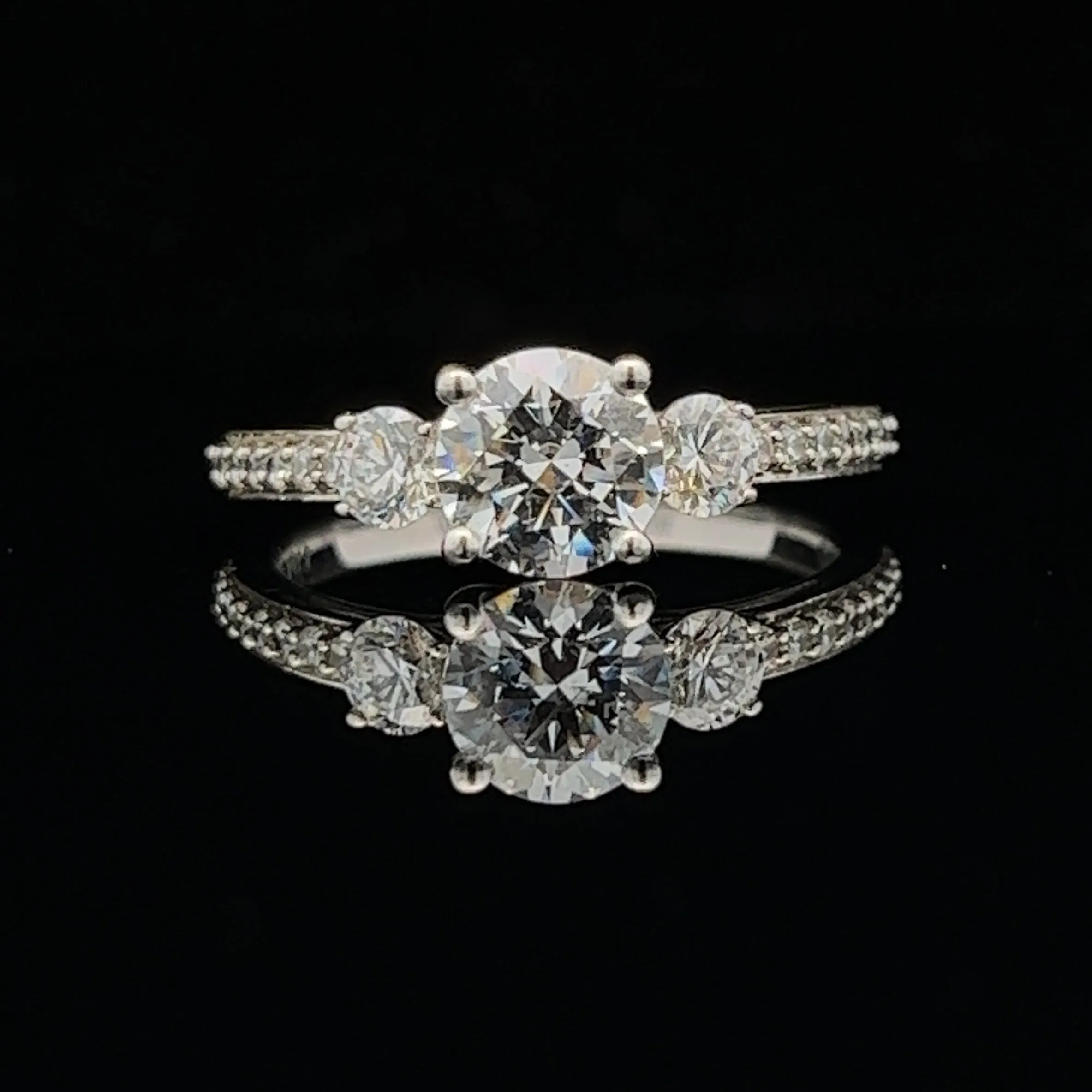 1 1/2 ctw three-stone round french-set diamond engagement ring