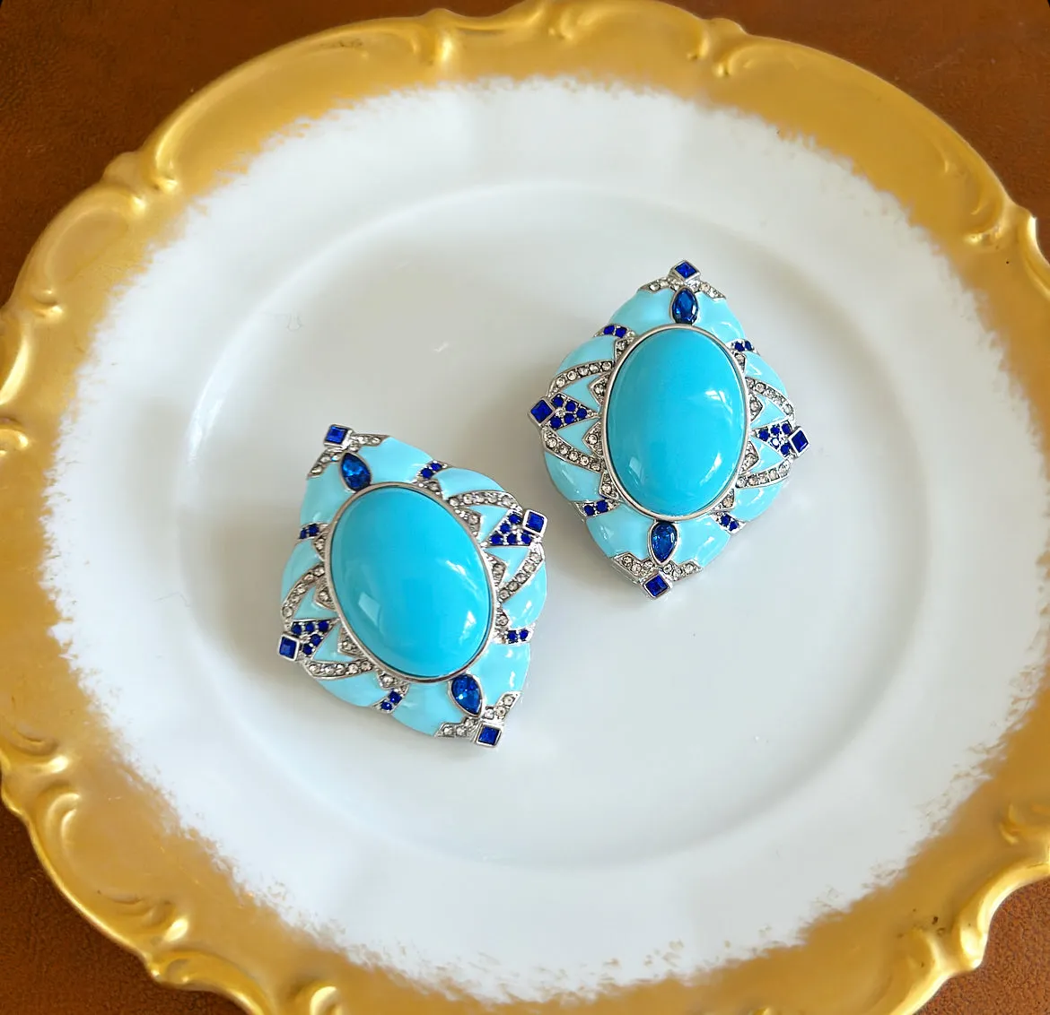 Large statement size pierced turquoise style earrings.